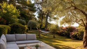 Un espace extérieur aménagé avec un canapé, une table et un hamac.