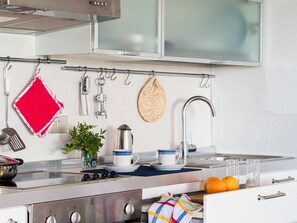 Fridge, oven, coffee/tea maker, cookware/dishes/utensils