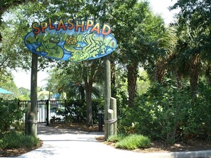 A sign for Splashpad with a colorful design featuring frogs and a crocodile. - 611 Lucaya (Davenport)