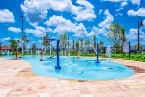 A water park with multiple water features and a clear blue sky.
