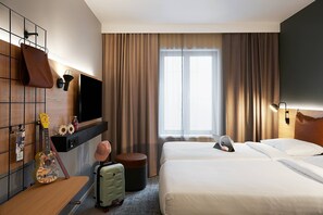 A hotel room with a bed, a television, a guitar, a suitcase, and a window with curtains. - Moxy Edinburgh (Edinburgh)