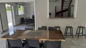 A modern dining area with a rectangular table and six chairs.