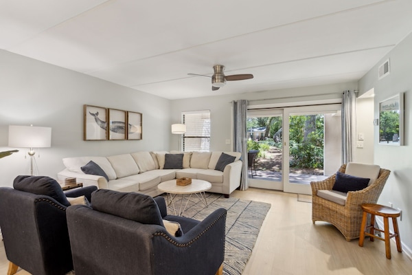 Plenty of Seating in Living Room with Sliders to Patio