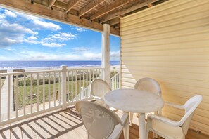 A covered outdoor area with a view of the ocean, featuring a table and chairs. - Beach front, updated townhome in Indian Pass~ Pelican Landing 2 (Indian Pass)