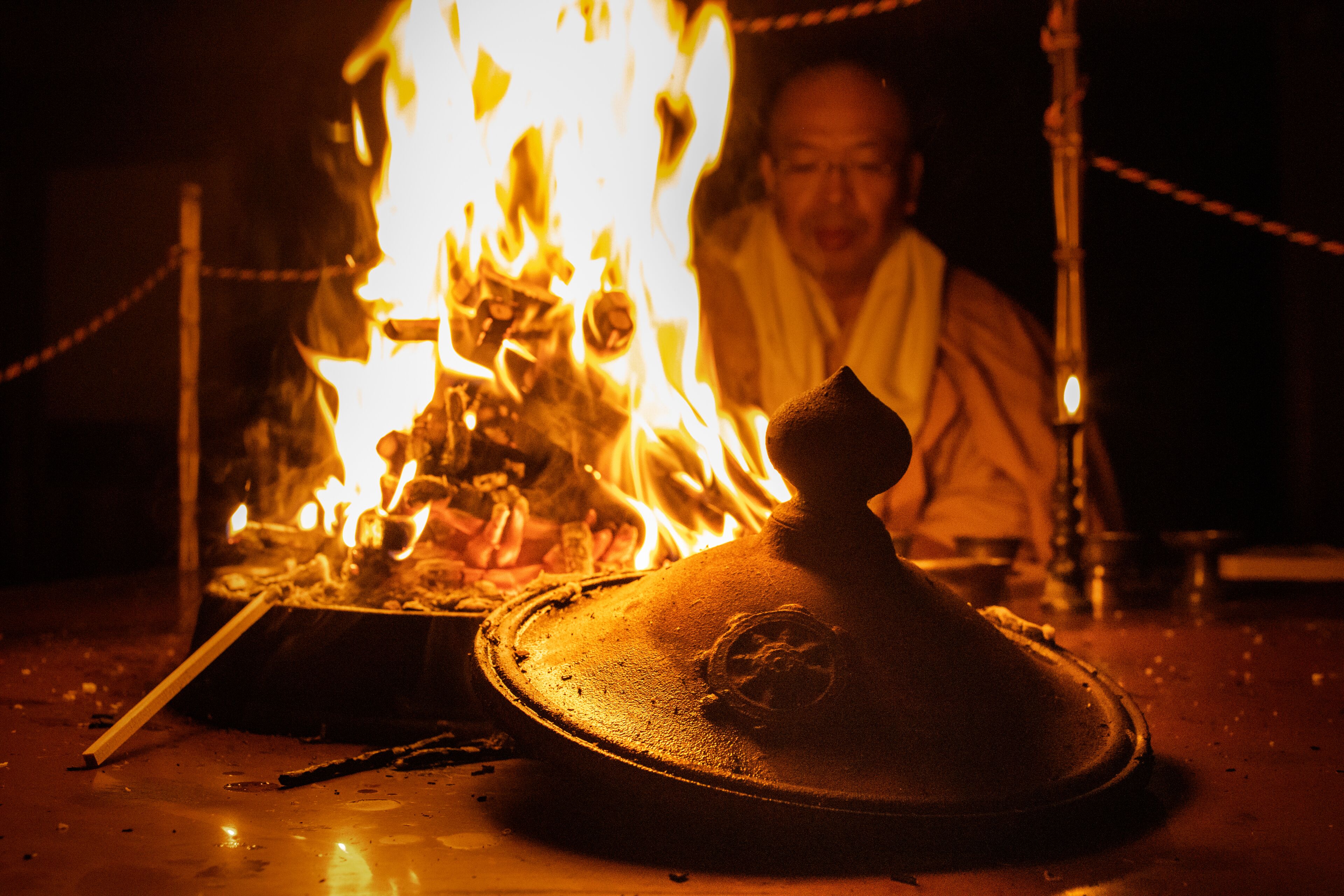 A traditional cooking setup with a large pot and a fire.