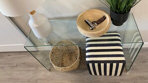 A glass table with a woven basket, a striped cushion, a wooden bowl with a belt, and a potted plant. - BRAND NEW FULL LUXURY REMODEL - Old Town Scottsdale! 2BR/2BA En-suite, Htd Pool! (Scottsdale)