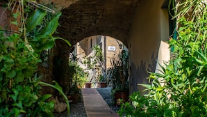 An arched passageway with a sign reading 'Largo' and potted plants. - Ca Veggia for Nature Lovers With Views & Garden (Stellanello)