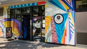 A building with colorful exterior artwork and a glass entrance. - Apartment Flamengo mit Küchenzeile - Rioca Vienna Posto 1 (Wien)
