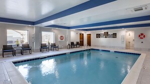 An indoor swimming pool with clear water, surrounded by lounge chairs and a tiled deck. - Comfort Suites St. Louis - Sunset Hills (St. Louis)