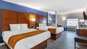 A hotel room with two beds, a desk, and a window with a city view. - Comfort Suites St. Louis - Sunset Hills (St. Louis)