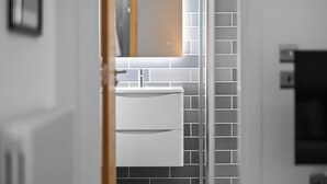 A modern bathroom with a white sink, a mirror, and a tiled backsplash. - Panmure Apartment - golf course views (Monifieth)