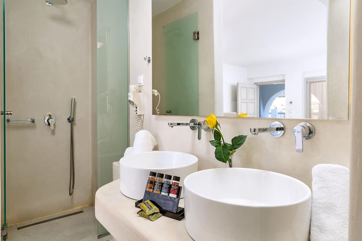 shower, hair dryer, slippers, towels