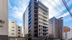 A multi-story building with a modern architectural design, featuring a central atrium and multiple balconies. - Edifice (Sapporo)