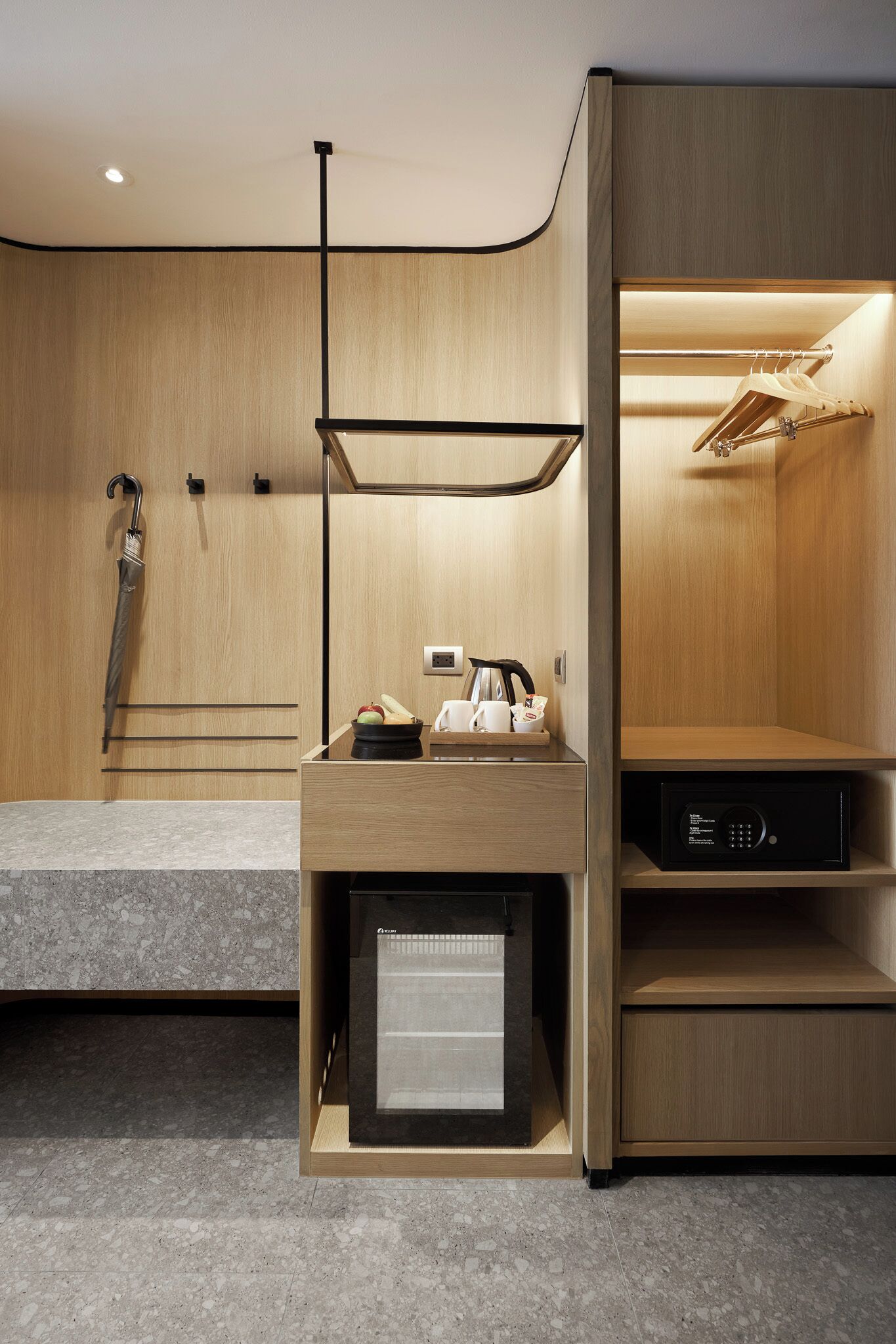A modern bathroom with a wooden vanity, a shower area, and a built-in heater.