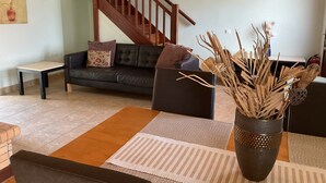 A living room with a sofa, a coffee table, and a vase with dried plants. - Villa Yason Private Heated Pool Within Easy Reach Of Beaches, Tavernas & Shops. (Ionian Islands)