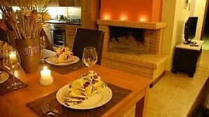 A dining area with a fireplace, candles, and a table set for two. - Villa Yason Private Heated Pool Within Easy Reach Of Beaches, Tavernas & Shops. (Ionian Islands)