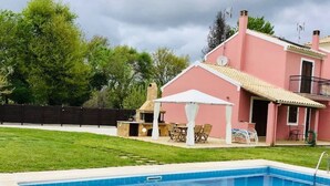 A swimming pool with a house in the background. - Villa Yason Private Heated Pool Within Easy Reach Of Beaches, Tavernas & Shops. (Ionian Islands)
