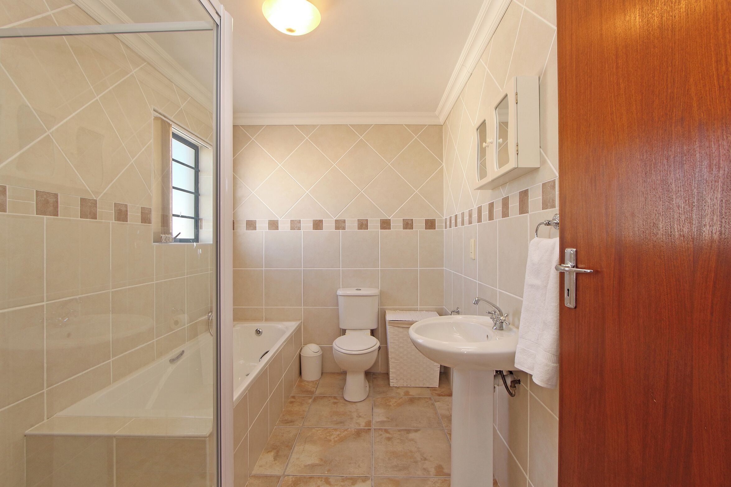 A bathroom with a bathtub, toilet, and sink.