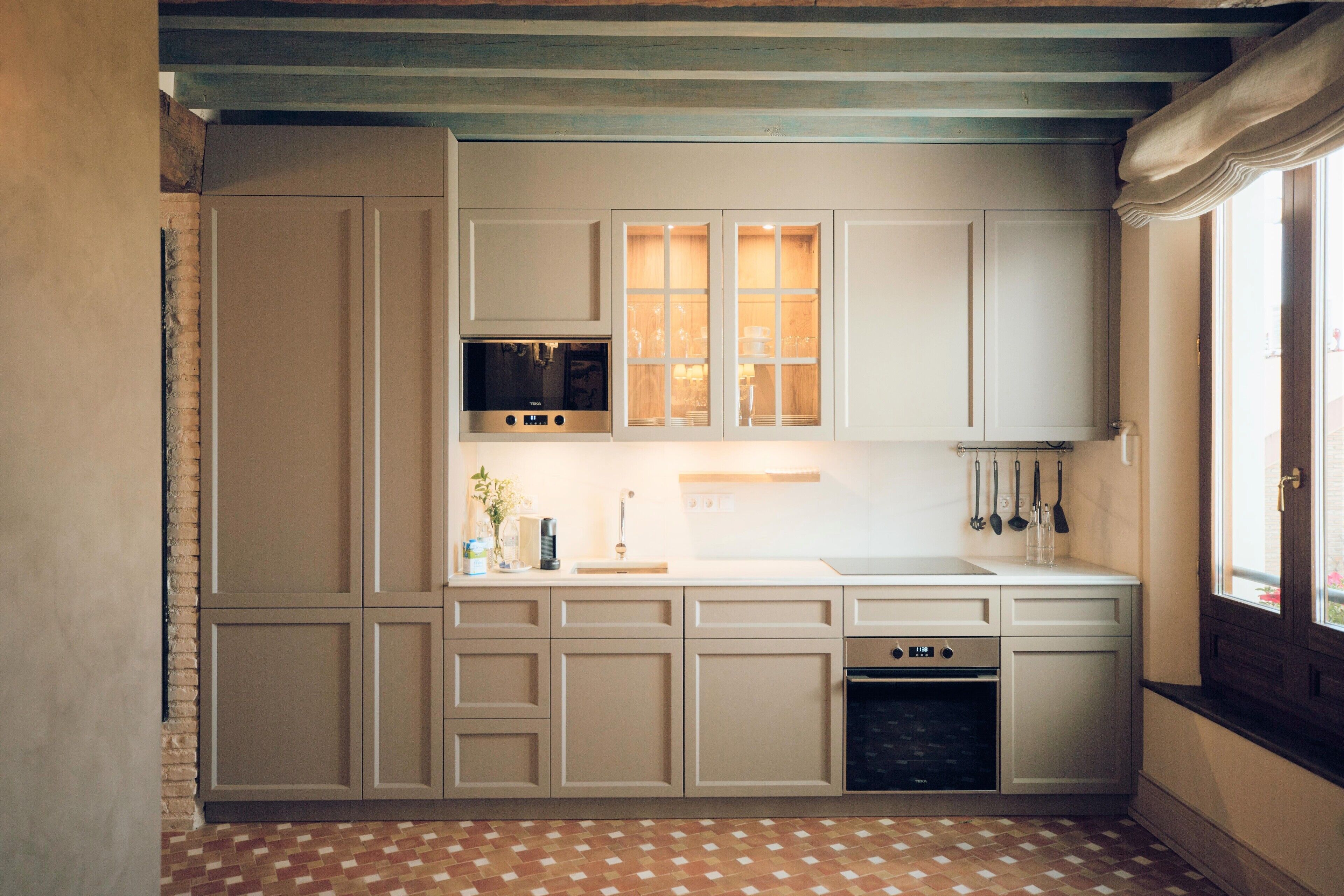A kitchen with white cabinets, a microwave, and a stove.