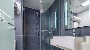 A modern bathroom with a glass shower enclosure, a white sink, and a mirror. - Hanting Hotel Hefei Guogou Plaza Branch (Hefei)