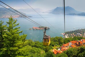 A cable car system with a view of a lake and distant mountains.