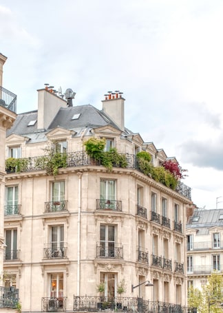 A multi-story building with ornate balconies, large windows, and a classic architectural style.