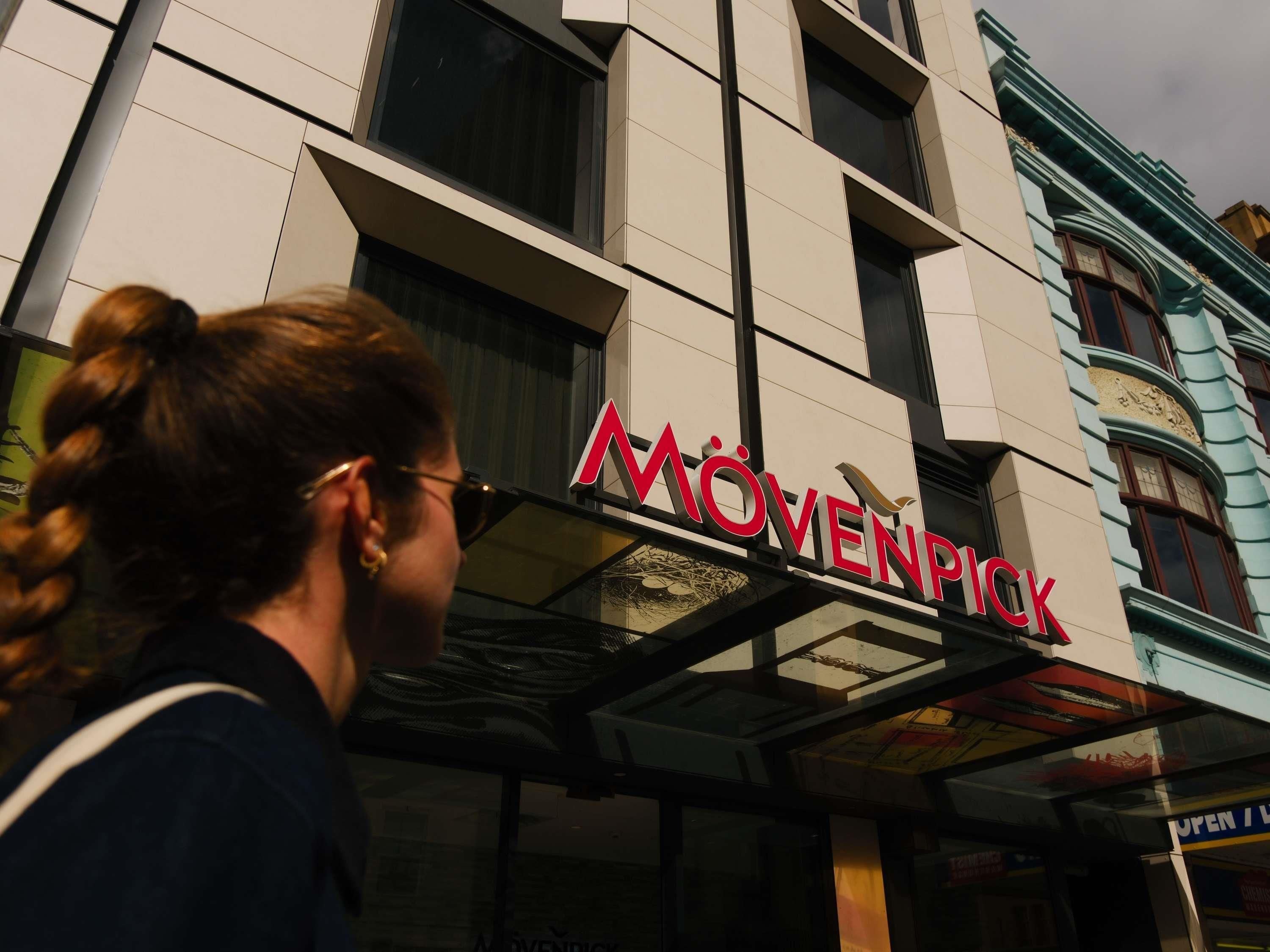 A building with a sign that reads 'MÖVENPICK' and a glass entrance.
