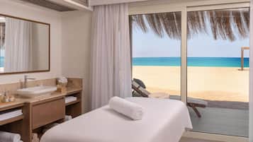 Enjoy a comfortable stay with a large bed, bathroom amenities, and a beach view.