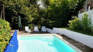 Una piscina al aire libre, una piscina climatizada