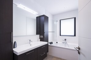 Combined shower/bathtub, towels, soap, toilet paper