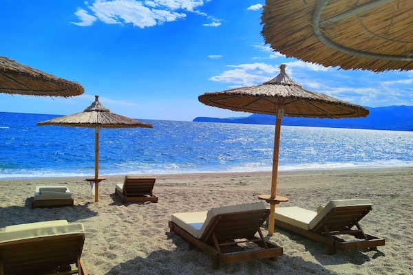 On the beach, sun loungers, beach umbrellas, beach towels
