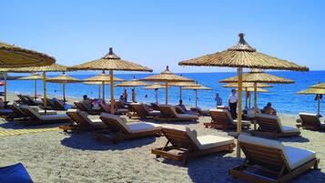 On the beach, sun loungers, beach umbrellas, beach towels