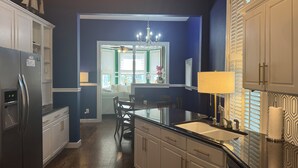A modern kitchen with a refrigerator, sink, and dining area. - Amazing location. Jackson St with pool.  Featured on #Staycation.  (Cape May)