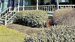 A Victorian-style house with a balcony, a porch, and a staircase leading to the entrance. - Amazing location. Jackson St with pool.  Featured on #Staycation.  (Cape May)