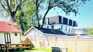 A backyard with a swimming pool, a wooden deck, and a house in the background. - Amazing location. Jackson St with pool.  Featured on #Staycation.  (Cape May)