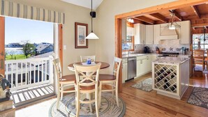 A spacious kitchen with wooden cabinets, a built-in wine rack, and a view of the outdoors.