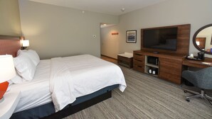 A hotel room with a bed, a desk, a television, a mirror, and a lamp. - Hampton Inn by Hilton Richwood Cincinnati South (Walton)