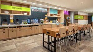 A modern kitchen area with a counter displaying various food items and a sign that reads "GOOD MORNING". - Home2 Suites By Hilton Alamogordo White Sands (Alamogordo)