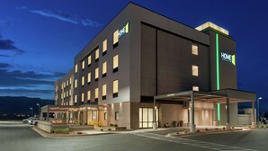 A modern hotel with a flat facade, multiple windows, and a covered entrance area. - Home2 Suites By Hilton Alamogordo White Sands (Alamogordo)