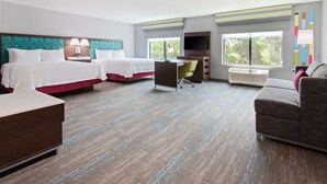 A hotel room with two beds, a desk, a chair, a TV, and a couch. - Hampton Inn & Suites Alachua I-75 (Alachua)