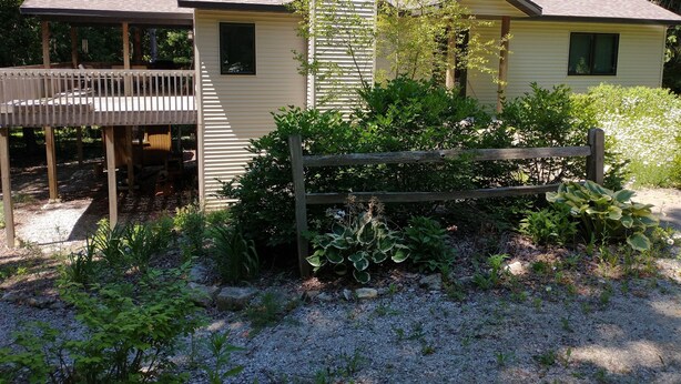 A two-story cabin with a deck and a chimney. - Cardinal Crest of Sister Bay (Sister Bay)
