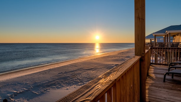 A wooden deck overlooking a beach with a sunset view. - Two Palms | Your Gulf-Front Happy Place. Pets Welcome (Dauphin Island)
