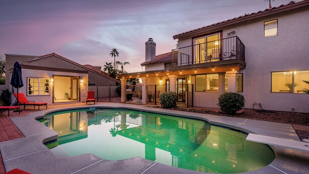 A two-story house with a swimming pool, a covered patio, and a fenced backyard. - Family-Friendly Retreat, Heated Pool, Putting Green (Scottsdale)