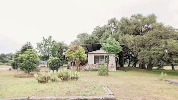 Surrounded by lush trees and a well-manicured lawn, this house offers a serene retreat.