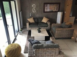Relax in this stylish living room with a sofa, coffee table, and armchair, perfect for unwinding.