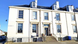 A white building with multiple windows and a sign that reads "Wellington Square." - Ayr Loft Apartment With Fabulous Views (Ayr)
