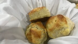 Tres galletas en un recipiente de papel blanco.