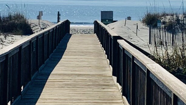 A wooden boardwalk leading to a beach with a clear view of the ocean. - Top Flr 3rd, Ocean View, Beach Bar & Rest, Nxt to Elevator, Pickleball & Tennis (Hilton Head Island)