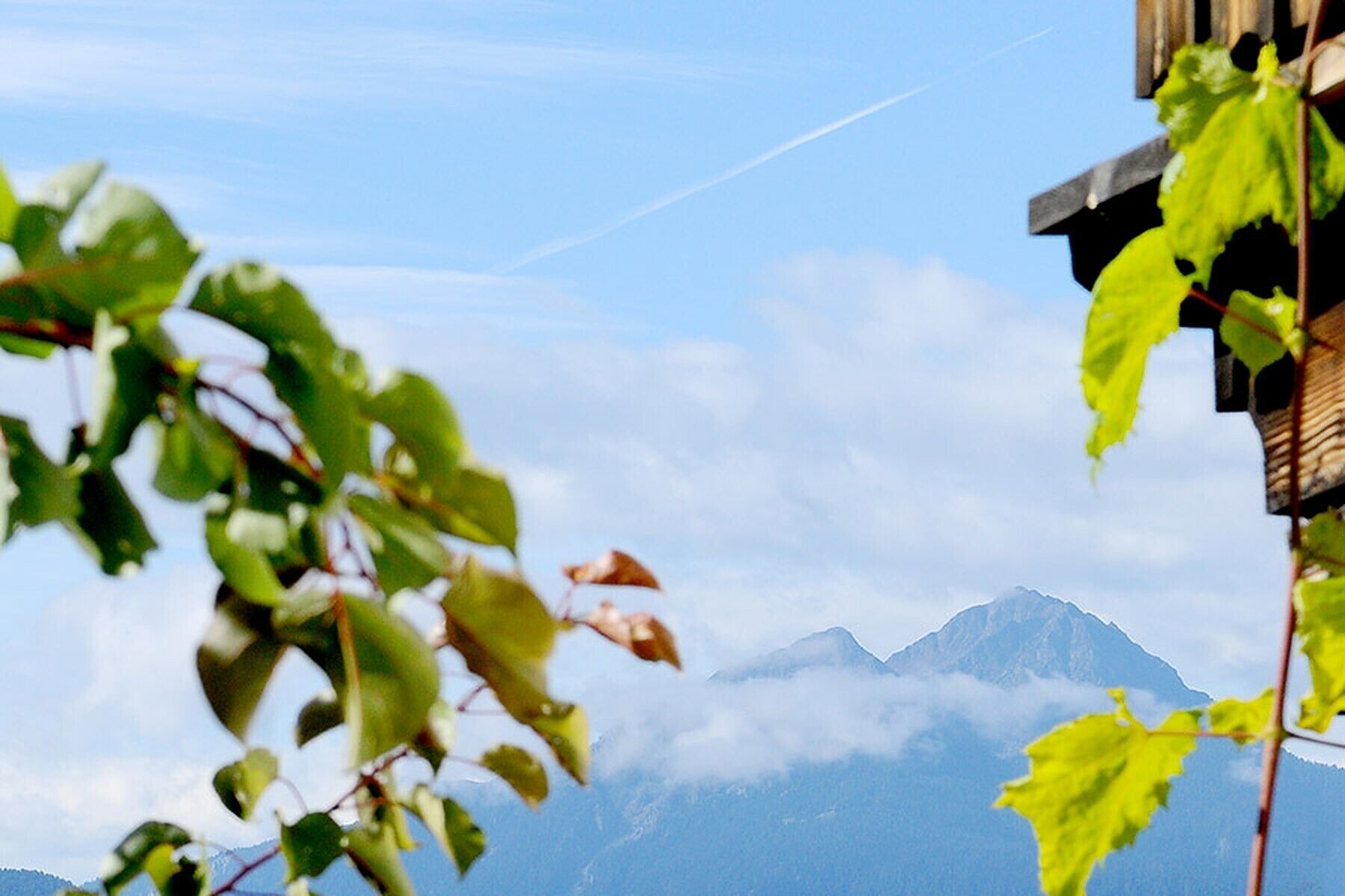 A mountain view with clouds and a clear sky.