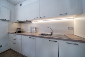 Fridge, stovetop, dishwasher, coffee/tea maker